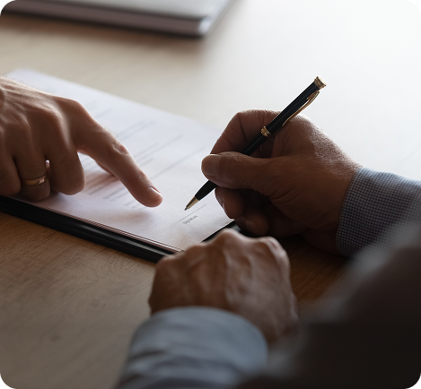 Lawyer pointing where to sign on a contract